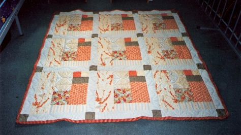 The Tangerine 9 block. It's on my spare bed. My first ever attempt at FMQ. And it shows!